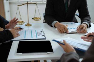 An image of a lawyer giving clients legal advice with scales near Lawrenceburg, Kentucky (KY)