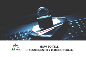 A padlock on credit cards on a wallet on a keyboard, symbolizing identity theft scam security.